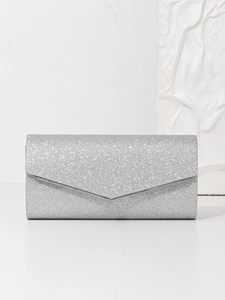 Detail of silver glitter evening clutch bag with envelope flap and metallic frame trim