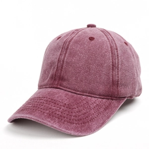 Macro detail of washed vintage cotton texture on a burgundy baseball cap with stitching
