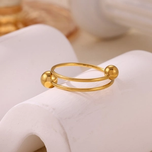 Detailed macro view of an 18k gold double-layered ring with elegant spiral bead accents