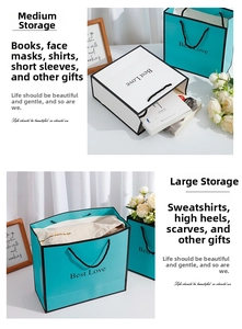 Detail view of Best Love paper gift bags showing medium and large sizes with handles