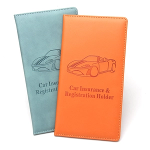 Macro detail of PU leather car document holders in light blue and orange with stitching