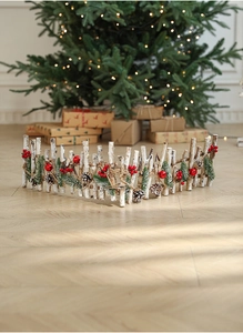 Macro detail of wood fence decorated with pine cones and red berries for Christmas decor