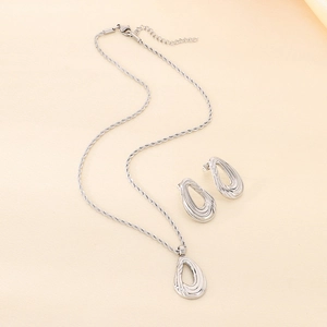 Detailed shot of silver hollow water drop jewelry set with twisted rope chain necklace