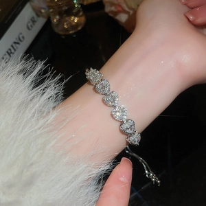 Close-up of sparkling heart-shaped diamond bracelet with adjustable slider clasp