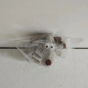 Detailed plush reindeer Christmas ornament showing soft grey and white faux fur textures