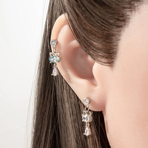 Silver cat stud earrings with light blue zircon stones and water drop pendants on model