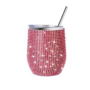 Detail of red rhinestone 12oz wine tumbler with transparent lid and metal straw