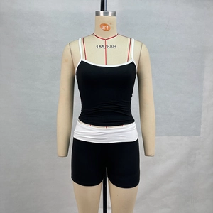 Detail view of black and white contrast stitching on athletic crop top and shorts set