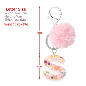 Resin letter S keychain with pink pompom and colorful heart sequins in acrylic finish