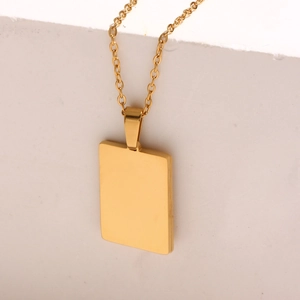Detail of an 18K gold-plated stainless steel rectangular pendant with sun engraving