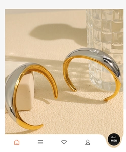 Close-up of gold and silver mixed metallic cuff bracelet with polished finish