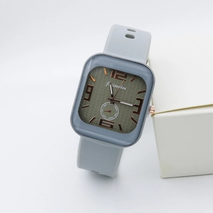 Detail of square quartz watch featuring olive textured dial and grey silicone strap