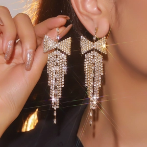 Luxurious gold butterfly tassel earrings with sparkling white cubic zirconia crystals