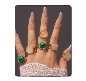 Lace sleeve model wearing vintage square malachite and crystal gold adjustable rings