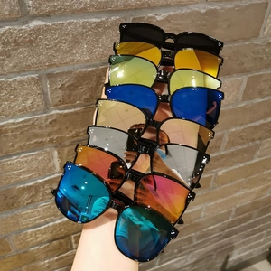 Detail shot of multi-color kids sunglasses with signature triple-point metal rivets