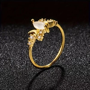 Detailed macro view of a gold marquise cut moonstone ring with sparkling side stones