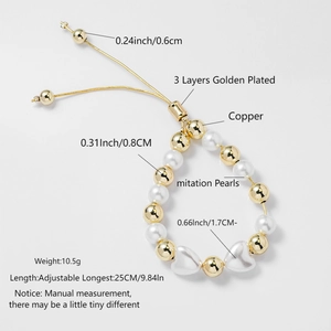 Detail view of two-tone beaded bracelet with gold copper beads, pearls and heart charms