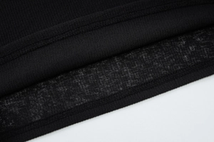 Détail de l'ourlet à double couture sur une chemise rayée noire en tissu respirant et léger