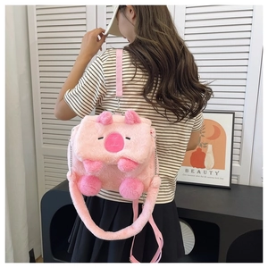 Pink plush cartoon backpack shown on model featuring adjustable straps and soft texture