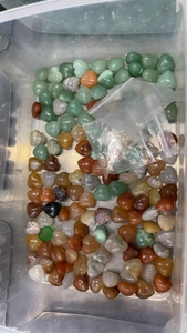 Macro shot of 15mm heart-shaped natural crystal stones in various colors and textures