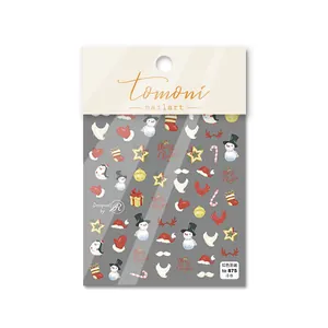 Detail of 3D embossed Christmas nail stickers featuring red snowmen and penguins