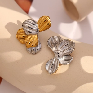 Macro shot of abstract dual-tone flower earrings with polished gold and silver finish