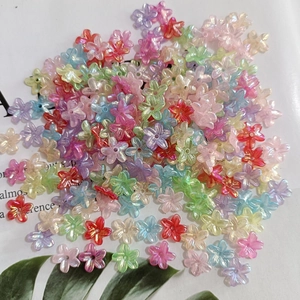 Macro detail of mixed-color pearlescent five-petal flower beads for jewelry making