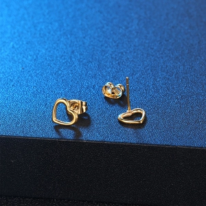 Minimalist hollow heart stud earrings in polished gold finish with butterfly backings