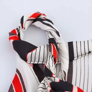 Macro shot of striped fabric twist detail and sharp stitching on asymmetrical top