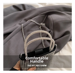 Detail view of the silver rhinestone encrusted handle on this luxury mini crossbody bag