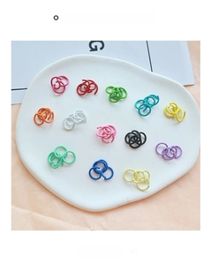 Flat lay of colorful 1.2x10mm painted metal open jump rings for DIY jewelry making