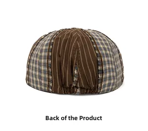 Rear view of patchwork flat cap showing frayed seams and adjustable elastic band
