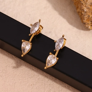 Macro shot of 18K gold plated teardrop zircon earrings on a black display strip