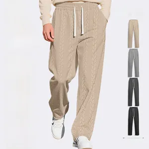 Detail of men's textured jacquard pants showing drawstring waist and side slit hem
