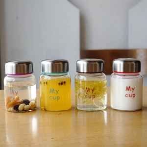 Close-up of 200ml heat-resistant glass mini jars with colorful seals and metal lids