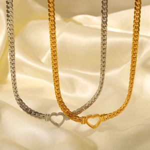 Gold and silver punk cuban chain necklaces with hollow heart pendants on silk fabric