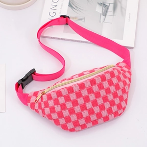 Close-up of pink checkered woven waist bag with golden zipper and adjustable strap