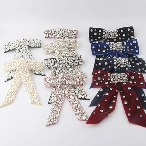 Luxurious rhinestone and pearl bow hair clips in velvet and crystal finishes