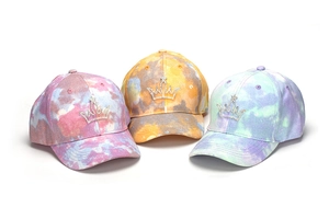 Detail of three tie-dye baseball caps for kids with sparkling rhinestone crown embroidery
