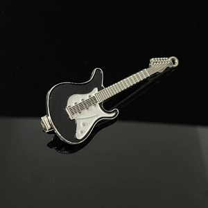 Detailed macro view of Y2K silver and black electric guitar alloy brooch with metallic finish