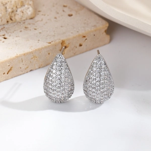 Close-up of teardrop stud earrings with silver plating and pavé white cubic zirconia
