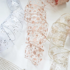 Detail of champagne gold and rose gold chiffon ribbons with glitter snowflakes and dots