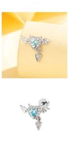 Close-up of heart wing cartilage stud with light blue zircon and silver feather detail
