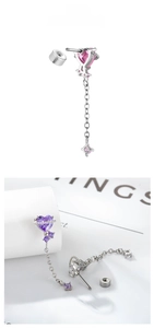 Detail of titanium steel heart pendant earrings with long chains and colorful crystals