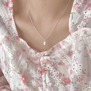 Elegant 925 sterling silver necklace with heart-shaped LOVE YOU gold pendant on model