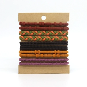 Set of 12 braided bohemian elastic hair ties in various colors on a display card