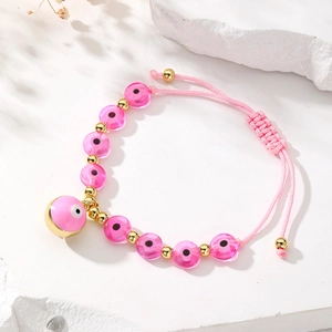 Bohemian handmade pink Evil Eye beaded bracelet with adjustable woven gold accents