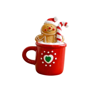 Christmas teacup resin ornament with gingerbread man and candy cane on white background