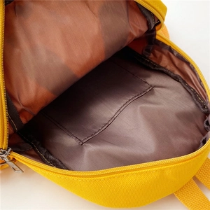 Internal structure of yellow canvas kids backpack with brown lining and open pocket