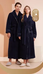 Detail view of navy blue thick flannel bathrobe with white trim and waist belt